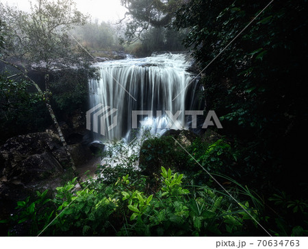 Pen Pob Mai Waterfall at Phu Kradueng National Park, Loei, Thailand. Landscape of waterfall in forest of Thailand during wet season. 70634763