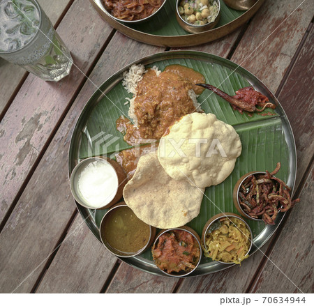 South Indian cuisine served on banana leaf. Top view. 70634944