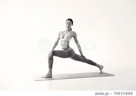 A beautiful girl is engaged in a yoga studio 70635899