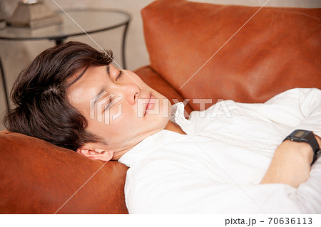 ソファで寝る男性 70636113