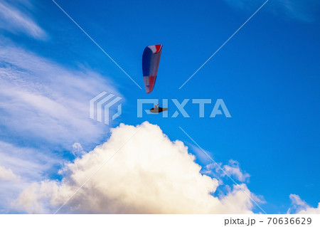 Paraglider flying over Scenic Mountain Range in Canadian Nature 70636629