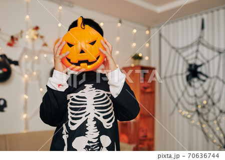Boy with jack o lantern 70636744