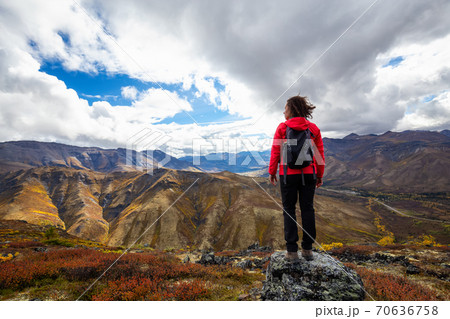 Woman Standing and Looking at Mountain Range 70636758