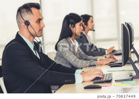 Business people wearing headset working in office Business people wearing headset working in office 70637449