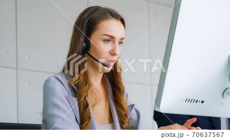 Business people wearing headset working in office Business people wearing headset working in office 70637567
