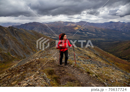 Woman Backpacking on Scenic Rocky Hiking Trail Woman Backpacking on Scenic Rocky Hiking Trail 70637724