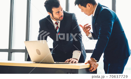 Two business people talk project strategy at office 70637729