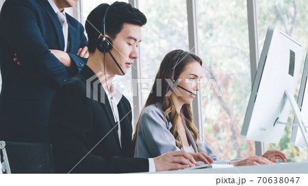 Business people wearing headset working in office Business people wearing headset working in office 70638047