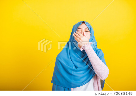 Asian Muslim Arab woman Islam wear hijab she sleepy yawning wide open mouth Asian Muslim Arab woman Islam wear hijab she sleepy yawning wide open mouth 70638149