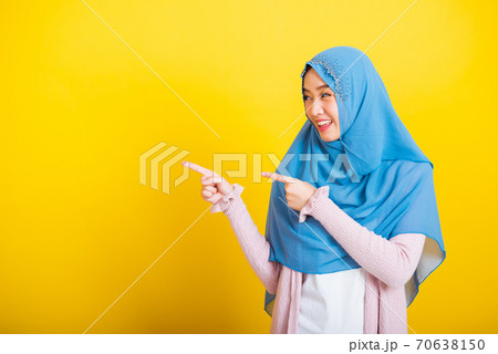 Asian Muslim Arab woman Islam wear hijab smile she positive expression pointing finger side Asian Muslim Arab woman Islam wear hijab smile she positive expression pointing finger side 70638150