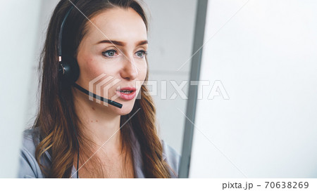 Business people wearing headset working in office Business people wearing headset working in office 70638269