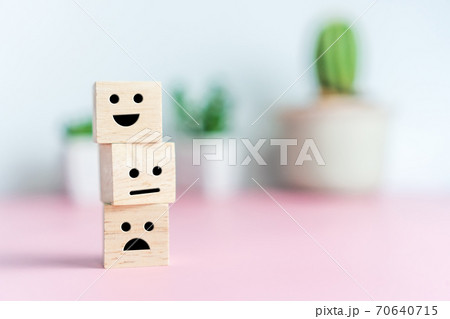 Smile face and cart icon on wood cube. Optimistic person or people feeling inside and service rating when shopping, satisfaction concept. Smile face and cart icon on wood cube. Optimistic person or people feeling inside and service rating when shopping, satisfaction concept. 70640715
