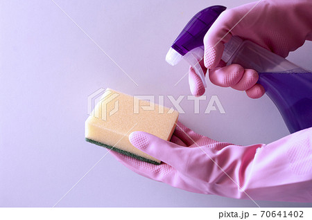 human hands in rubber gloves holding sponge and spray bottle detergent. House cleaning concept 70641402