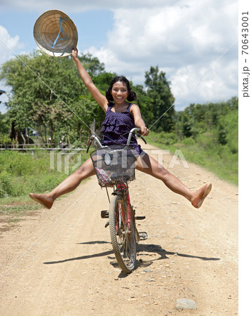 cheerful girl goes on a bicycle cheerful girl goes on a bicycle 70643001