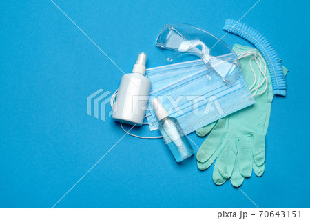 Safety equipment to fight to Coronavirus COVID-19 virus outbreak - Safety mask, hand sanitizer, latex gloves and protective glasses or goggles Safety equipment to fight to Coronavirus COVID-19 virus outbreak - Safety mask, hand sanitizer, latex gloves and protective glasses or goggles 70643151