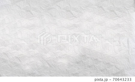 Heavily crumpled sheet of white paper with a textured surface .Texture or background 70643233