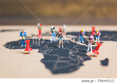 Miniature people backpacker walking on world map 70644513