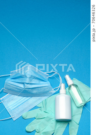 Safety equipment to fight to Coronavirus COVID-19 virus outbreak - Safety mask, hand sanitizer, latex gloves and protective glasses or goggles 70646326