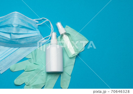 Safety equipment to fight to Coronavirus COVID-19 virus outbreak - Safety mask, hand sanitizer, latex gloves and protective glasses or goggles 70646328