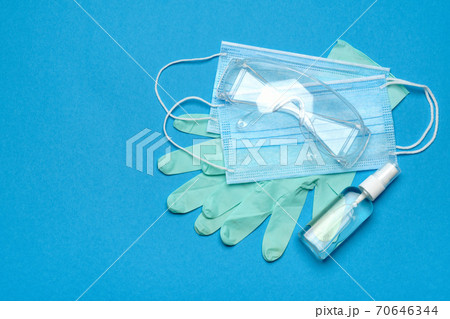 Safety equipment to fight to Coronavirus COVID-19 virus outbreak - Safety mask, hand sanitizer, latex gloves and protective glasses or goggles Safety equipment to fight to Coronavirus COVID-19 virus outbreak - Safety mask, hand sanitizer, latex gloves and protective glasses or goggles 70646344