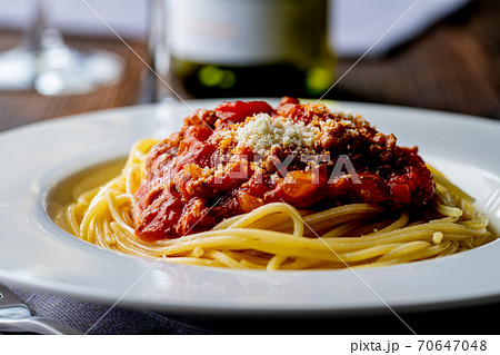 Pasta with meat and tomato sauce on wooden table. 70647048