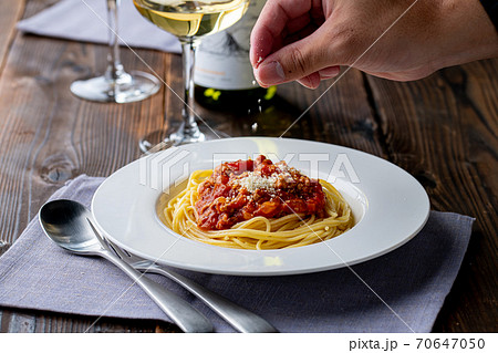 Pasta with meat and tomato sauce on wooden table. 70647050