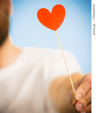 Man with heart on stick 70649493