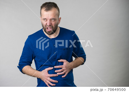 Man feeling stomach ache pain Man feeling stomach ache pain 70649500