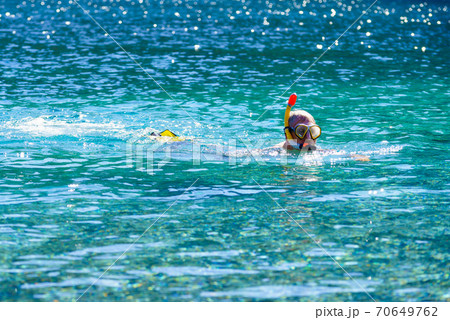 Man with snorkeling tube in sea 70649762