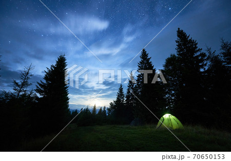 Magical starry night at a campsite in the mountains during summer time Magical starry night at a campsite in the mountains during summer time 70650153