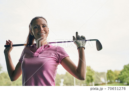 Happy Caucasian golfer with a beaming smile 70651276