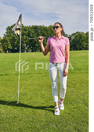 Thoughtful sportswoman with a club staring away 70652009