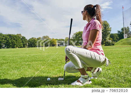 Golfer in sunglasses looking into the distance 70652010