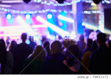Music Concert background blur. Blurred People dancing with original bokeh lights in background - Defocused image for an artistic touch of disco club - Concept of nightlife with music and entertainment Music Concert background blur. Blurred People dancing with original bokeh lights in background - Defocused image for an artistic touch of disco club - Concept of nightlife with music and entertainment 70652172