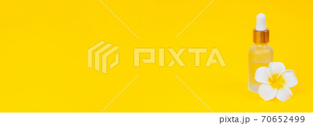 Banner for website cosmetic oil in dropper bottle on yellow background with place for text. 70652499