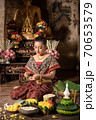 Thai girl in traditional dress costume making and decorating Krathong. Loy Krathong Festival. 70653579