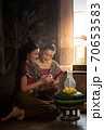 Two thai woman in traditional dress costume making and decorating Krathong. Loy Krathong Festival. 70653583