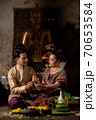 Thai couple in traditional dress costume making and decorating Krathong. Loy Krathong Festival. 70653584