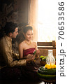 Thai couple in traditional dress costume making and decorating Krathong. Loy Krathong Festival. 70653586