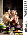 Thai couple in traditional dress costume making and decorating Krathong. Loy Krathong Festival. 70653588