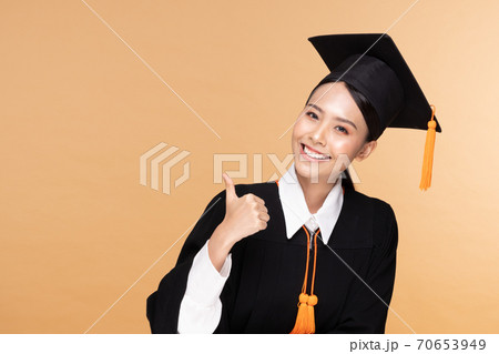 Beautiful Attractive Asian woman graduated in cap and gown smile so proud and happiness,Isolated on Beige background,Education Success Concept Beautiful Attractive Asian woman graduated in cap and gown smile so proud and happiness,Isolated on Beige background,Education Success Concept 70653949