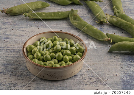 fresh raw peas on a wooden table 70657249