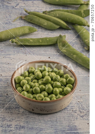 fresh raw peas on a wooden table fresh raw peas on a wooden table 70657250