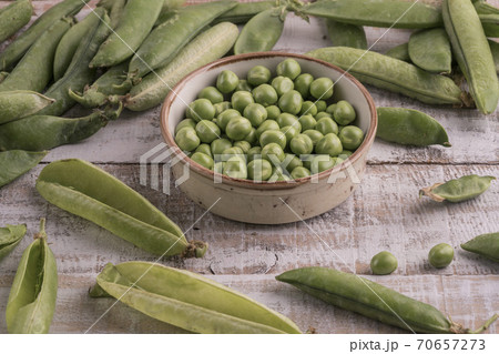 fresh raw peas on a wooden table 70657273