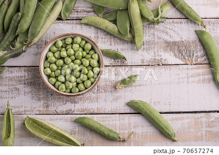 fresh raw peas on a wooden table 70657274