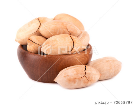 Pecan nuts in wooden bowl, isolated on white background. Unshelled pecan. 70658797