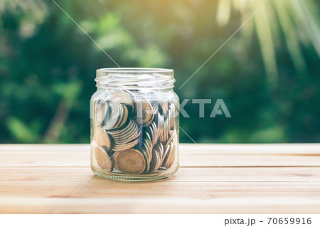 Money in a jar. money in a jar represents for a saving to buy a house or invest. planning savings money of coins to buy a home concept property mortgage and investment or saving for buy house. Money in a jar. money in a jar represents for a saving to buy a house or invest. planning savings money of coins to buy a home concept property mortgage and investment or saving for buy house. 70659916