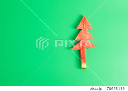 Christmas tree of watermelon on green background. Merry Xmas and happy New Year party, Celebrating and dessert concept 70663136