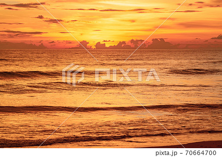 View of Beautiful glorious golden sunset and golden hour above the sea in evening View of Beautiful glorious golden sunset and golden hour above the sea in evening 70664700