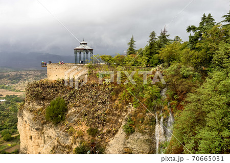 Scenic sight of Ronda with white houses built on high cliffs, Andalusia, Spain. Scenic sight of Ronda with white houses built on high cliffs, Andalusia, Spain. 70665031